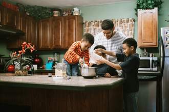 father baking with sons