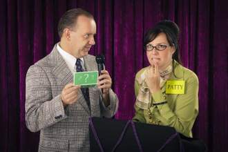 female contestant trying to answer a question asked by the game show host