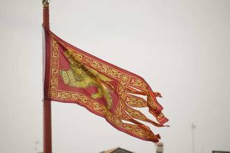 flag of venice flying high on a flagpole