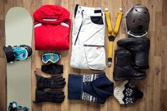 flatlay of snow boarders clothing and equipment
