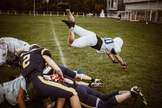 football quarterback passing through defense for a touchdown