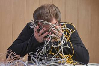 frustrated man holding tangled chores up to his face