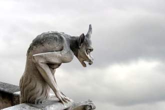 gargoyle statue against overcast sky
