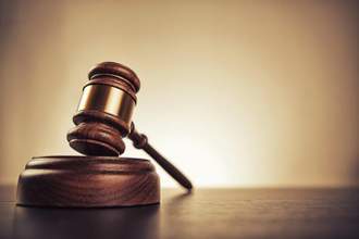 gavel sitting on a wooden desk