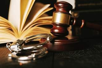 gavel with handcuffs and lawbook