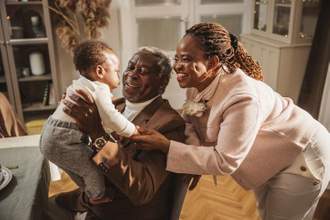grandparents looking adoringly at their grandchild