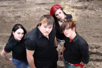 group of four alternative kids wearing black and looking up at the camera