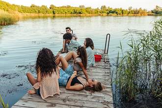 group of friends sitting on dock