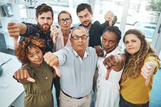 group of people looking at you with their thumbs down