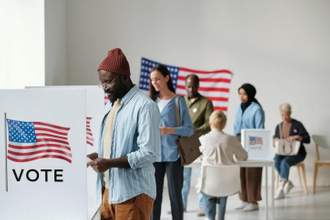 group of people standing in line getting ready to vote