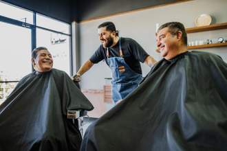hair stylist talking to customers at the barber shop