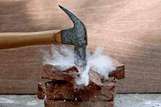 hammer smashing bricks