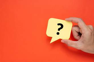 hand holding up question mark speech bubble