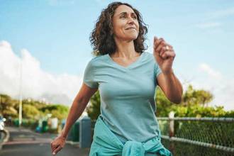 healthy woman taking a brisk walk outdoors