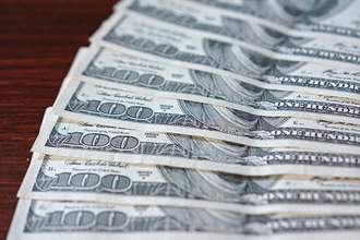 hundred dollar bills fanned on table