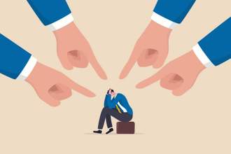 illustration of a businessman sitting on his bag holding his head in his hands while large hands point in his directions