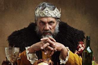 king with a huge meal in front of him