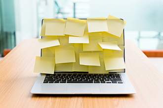 laptop covered with post it notes