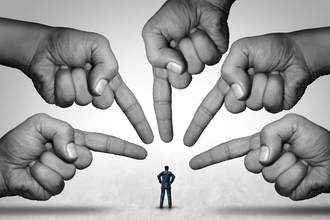 large hands pointing accusingly at a small human