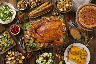 large spread of thanksgiving food on a dinning table