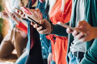 line of people holding their phones