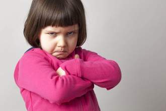 little girl looking upset and pouting at the audience