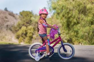 little girl riding on her tricycle