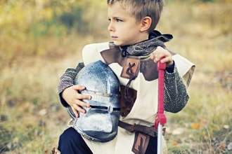 little kid kneeling wearing a knights custom