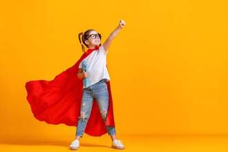 little superhero holding her notebook and putting her fist in the air