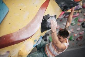 man climbing a rock wall