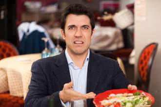 man complains about food in restaurant