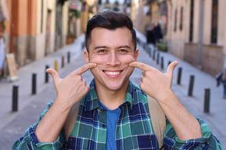 man faking smile