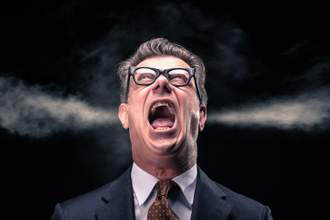 man in a suit yelling with steam coming out of his ears