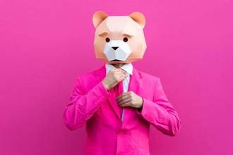 man in hot pink suit and origami paper bear mask