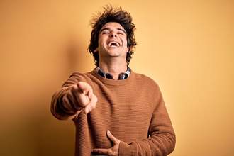 man laughing pointing at camera