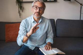 man looking at the camera and talking