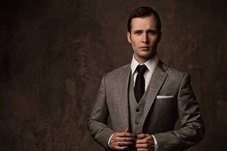 man looking dapper in a gray three piece suit