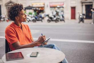 man looking off into the distance while thinking of new ideas for his writing piece