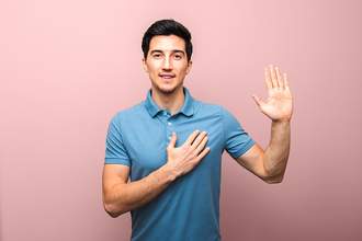 man making promise with hand to chest