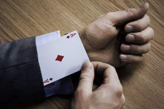man pulling out an ace card from his suit jacket