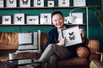 man relaxing on sofa at cozy home holding insect collection
