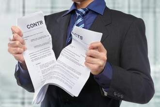 man ripping a contract in half
