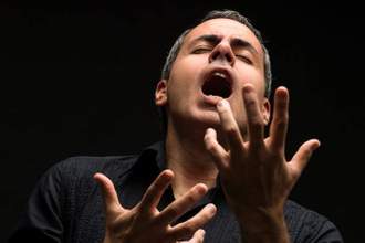 man singing dramatically out of his throat
