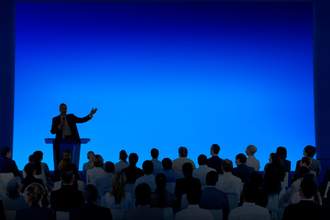 man speaking at lectern