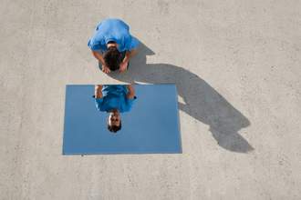 man staring at mirror on ground