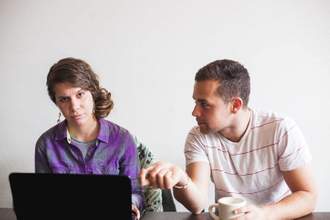 man talking to a woman at work and she doesnt look interested