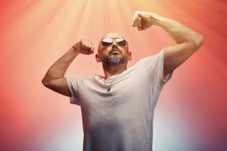 man wearing sunglasses flexing his arm muscles