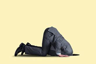 man with head in hole in floor