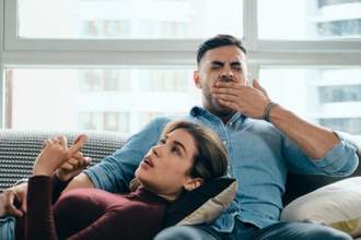 man yawning during conversation with partner