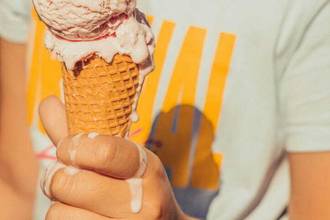 melting ice cream cone in childs hand